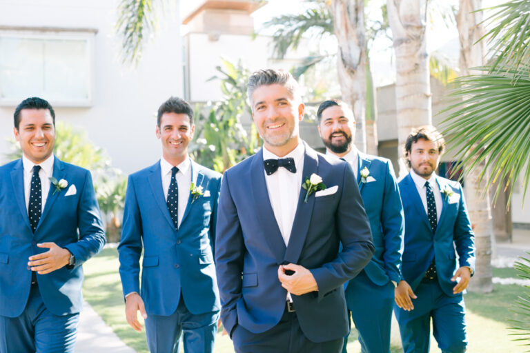Groom and groomsmen in blue suits walking together, Nilyum Wedding and Event Design