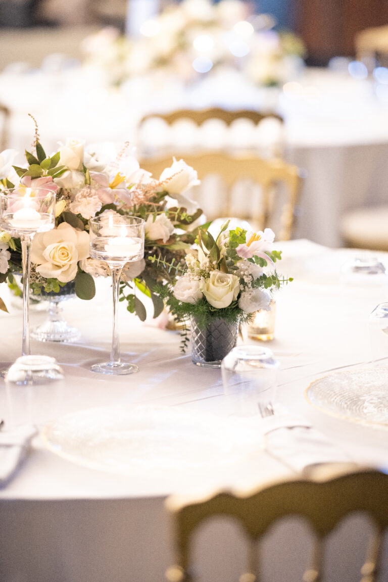 White roses and place settings on a banquet table, Nilyum Wedding and Event Design