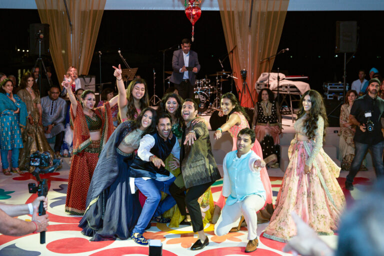 Wedding guests dancing and posing at the sangeet, Nilyum Wedding and Event Design