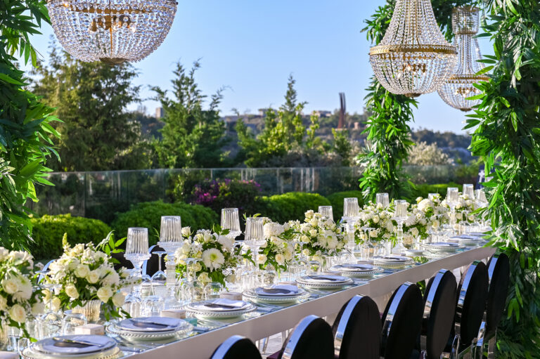 Long garden banquet table with white flowers, greenery and crystal chandeliers, Nilyum Wedding and Event Design