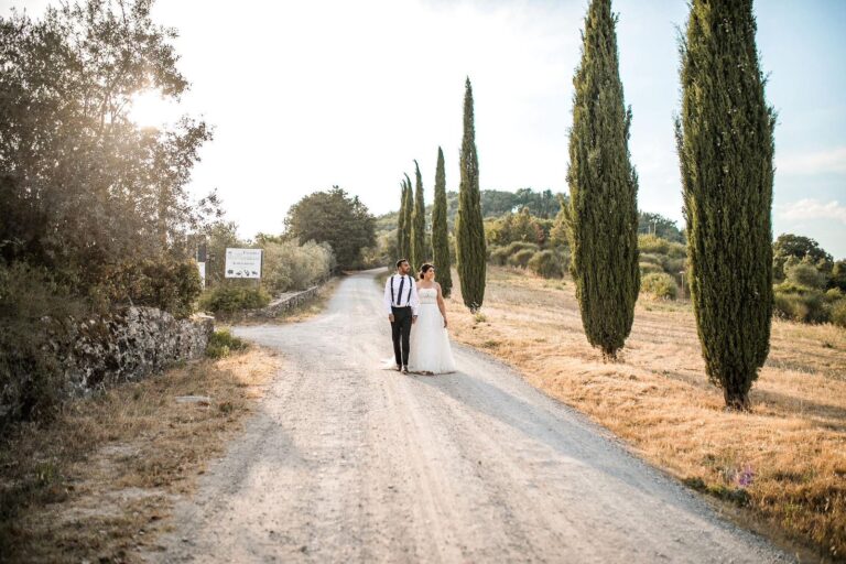 A couple on a white road lined with cypresses, Montelucci Country Resort, Tuscany, Noemi Wedding