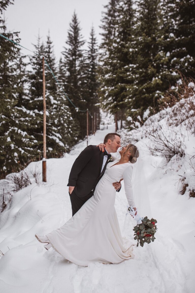 A winter wedding on a cleared path through deep snow among spruce, the Dolomites, Noemi Wedding