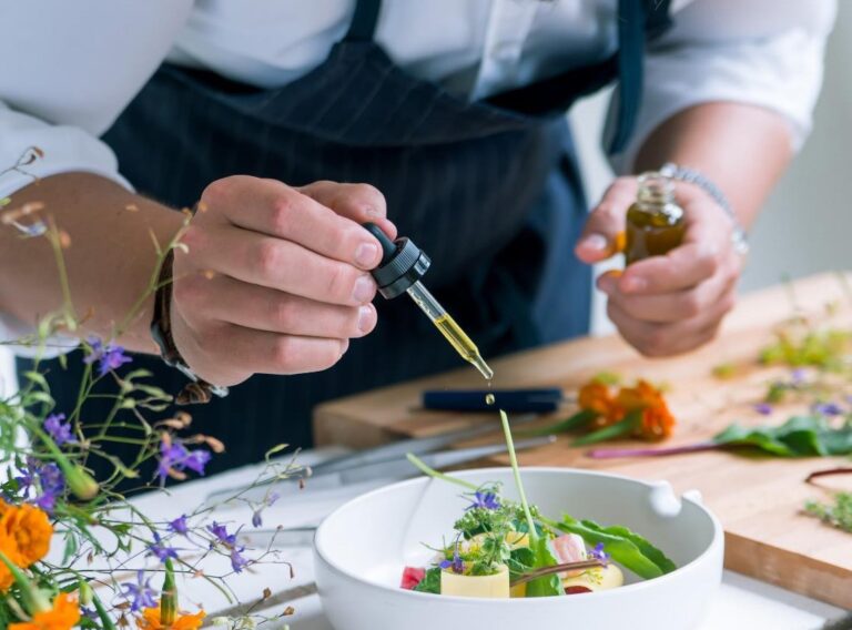 Chef finishing a dish with herbs and flowers, Non Such Mansion