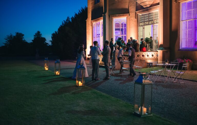 Lantern-lit lawn outside the mansion in the evening, Non Such Mansion