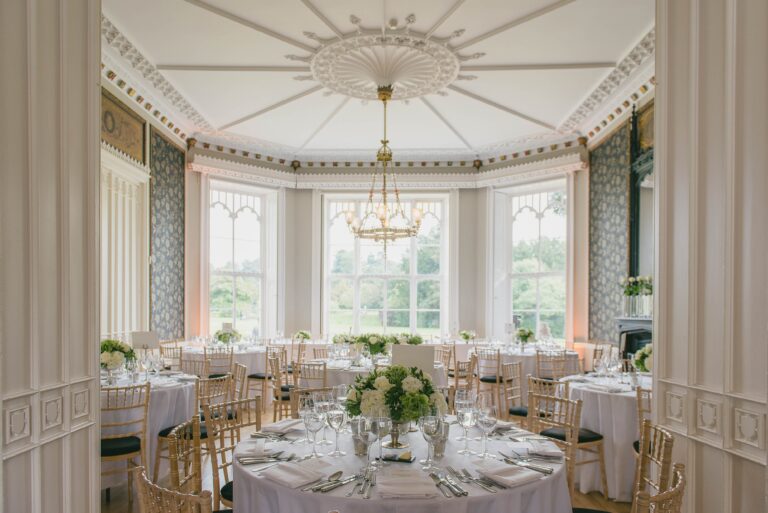 Round tables laid for a wedding breakfast in the bay-windowed room, Non Such Mansion