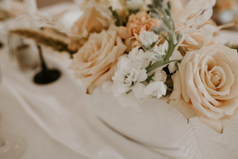 Wedding table flowers in cream and peach, Nordic Adventure Weddings