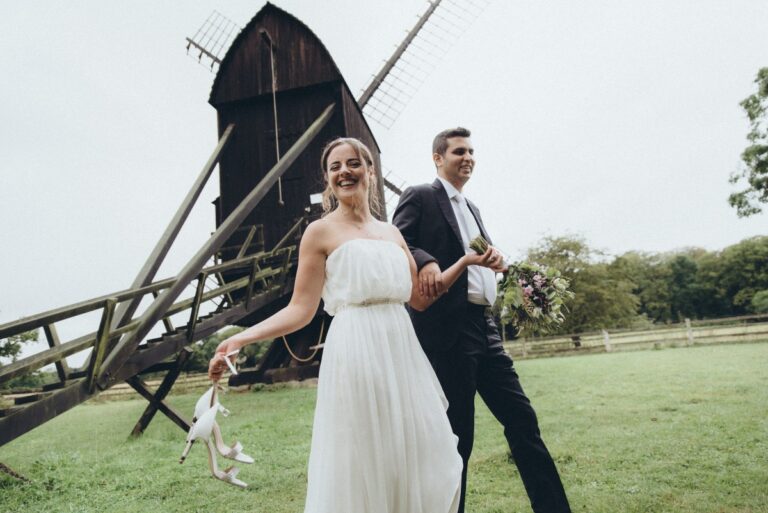 Bride and groom in front of a windmill, Nordic Adventure Weddings