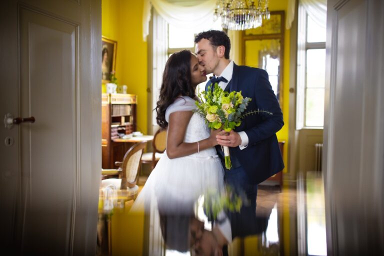 Couple kissing in a yellow-walled room, Nordic Adventure Weddings