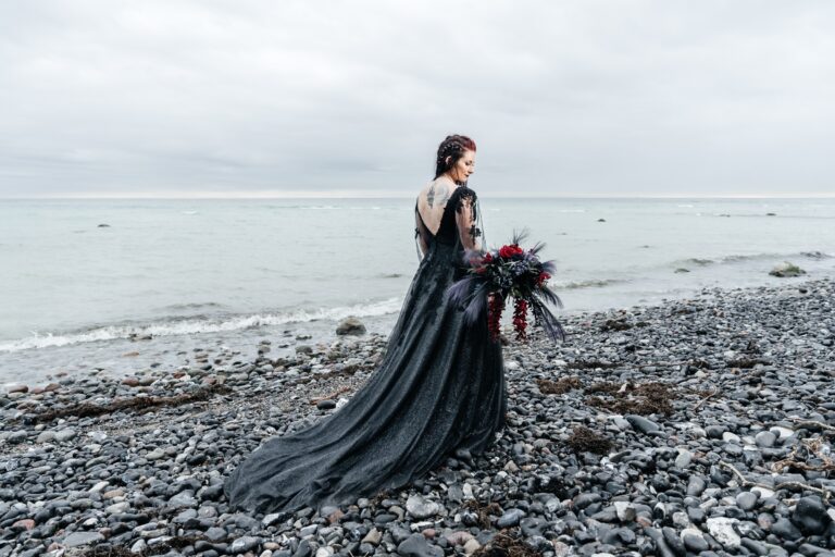 Bride in a black gown on a pebble beach, Nordic Adventure Weddings