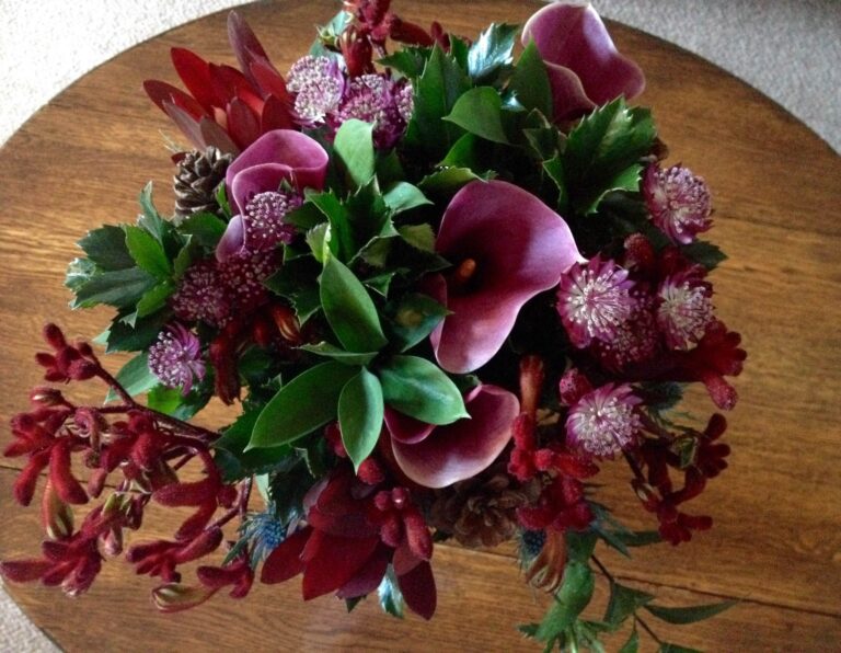 A table arrangement of deep red calla lilies, astrantia and foliage, Northcote Manor Hotel