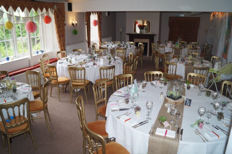 Round tables dressed for a wedding breakfast with hessian runners, glassware and table numbers, Northcote Manor Hotel