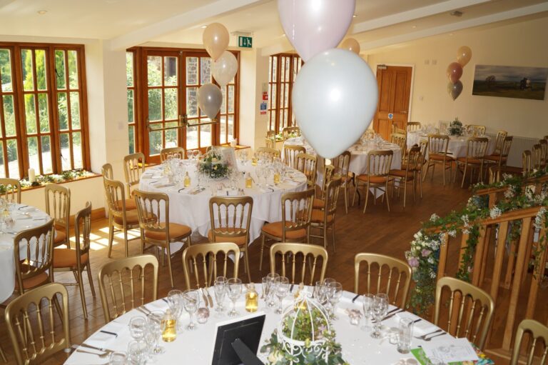 The conservatory set with round tables and balloons for a wedding breakfast, Northcote Manor Hotel