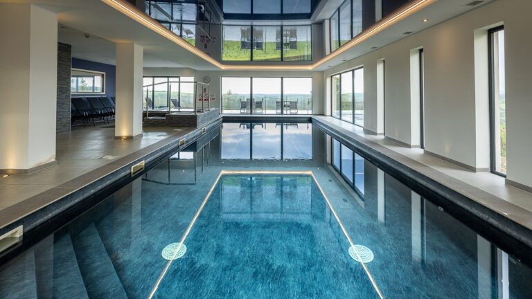 The indoor pool in the spa, with a wall of windows facing the countryside, Northcote Manor Hotel