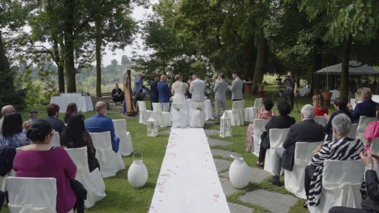 An outdoor ceremony in a garden, white aisle and harpist, from Elisa and Davide's trailer, Nozze da film