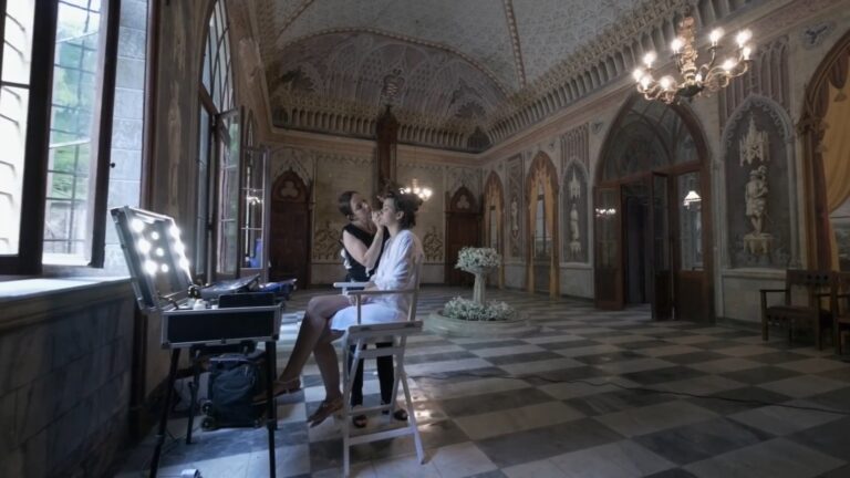 Bridal make-up in a frescoed hall under a chandelier, from Lucia and Carlo's trailer, Nozze da film