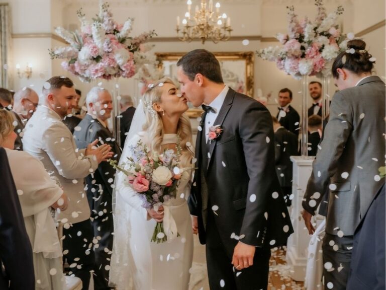 A couple leaving the Crystal Suite at Nunsmere Hall, confetti falling, Nunsmere Hall Hotel