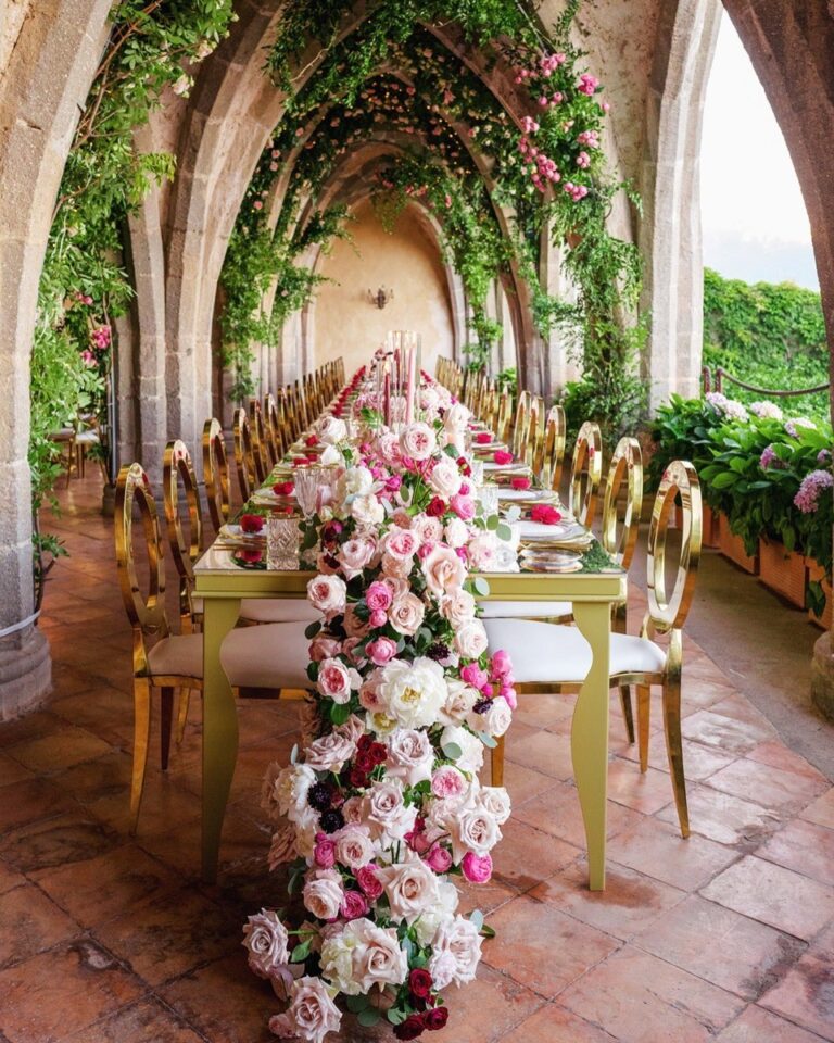 A long table dressed with flowers in an arched loggia, Nunta pe Plaja