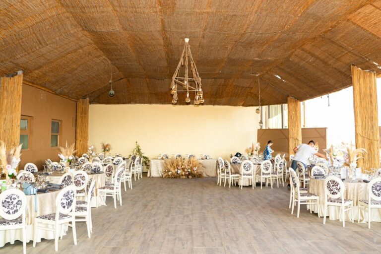 A covered beach venue set for a wedding dinner, Nunta pe Plaja