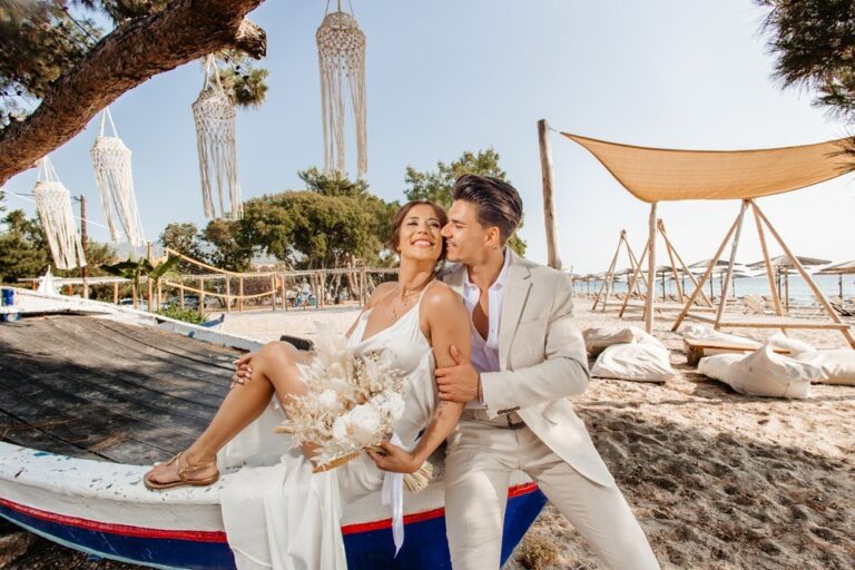 A couple seated in a boat on the beach, Nunta pe Plaja