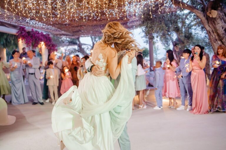 Wedding guests dancing at an evening reception, Nunta pe Plaja