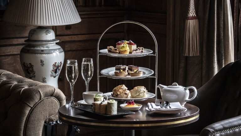 Afternoon tea, a tiered stand of cakes and scones with a glass of Champagne, Nutfield Priory Hotel & Spa