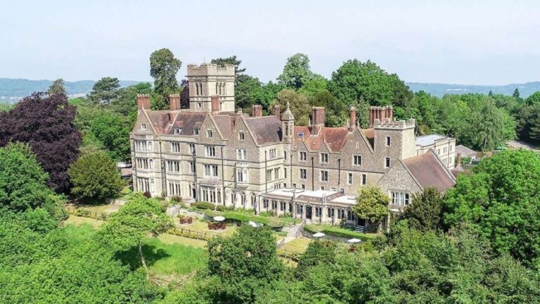 Nutfield Priory, the Neo-Gothic Victorian mansion, seen from the air amid its wooded grounds on Nutfield Ridge, Nutfield Priory Hotel & Spa