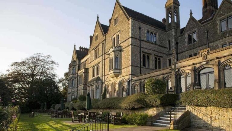 The honey-stone Victorian frontage of Nutfield Priory above its garden terraces, Nutfield Priory Hotel & Spa