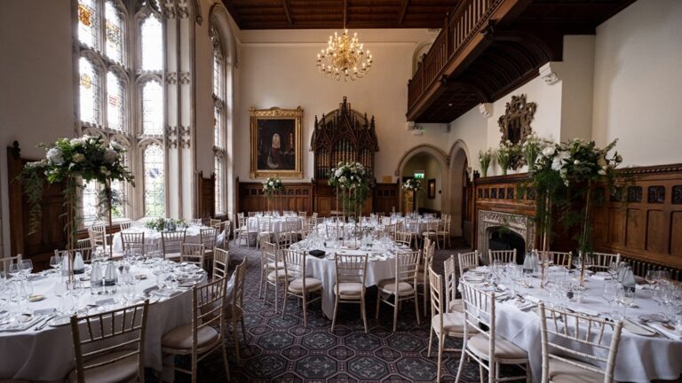The galleried Great Hall dressed for a wedding breakfast, round tables beneath the minstrels' gallery and stained glass, Nutfield Priory Hotel & Spa