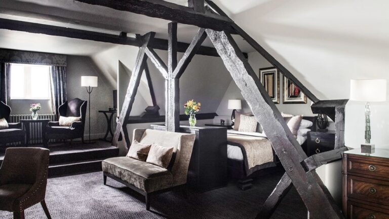 The Tennyson Master Suite, a four-poster beneath the exposed timbers of the tower, Nutfield Priory Hotel & Spa