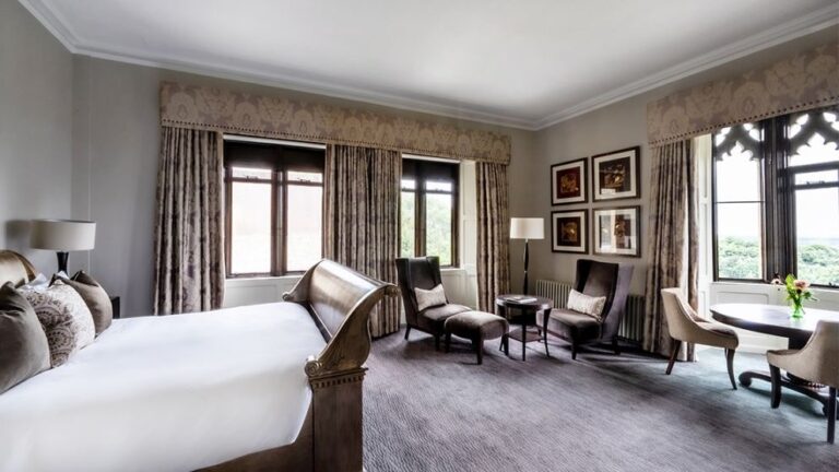 A suite with its own sitting area and views over the Surrey countryside, Nutfield Priory Hotel & Spa