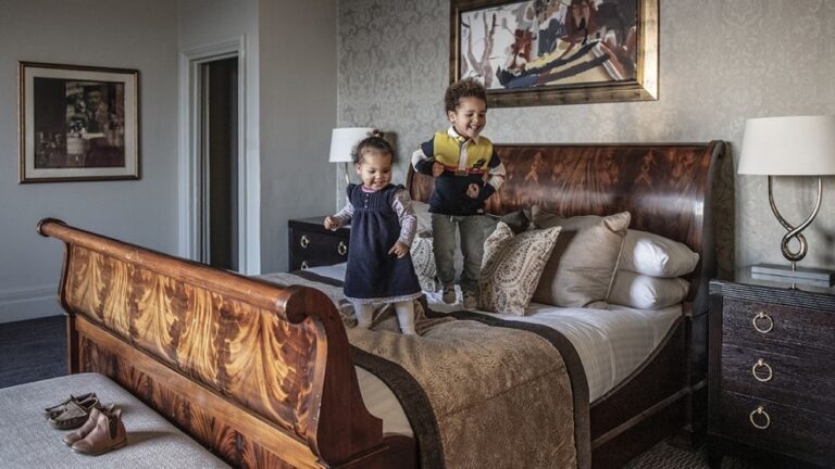 A family suite, children at play on a sleigh bed, Nutfield Priory Hotel & Spa