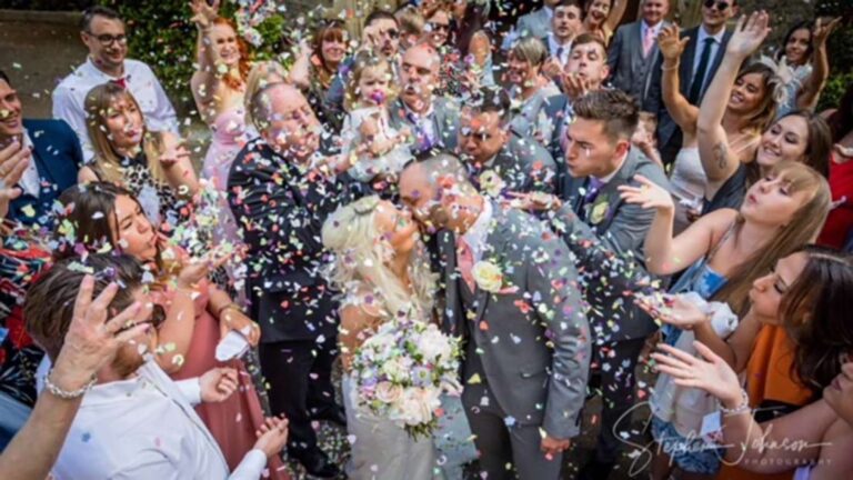 Newlyweds showered in confetti by their guests outside the mansion, Nutfield Priory Hotel & Spa