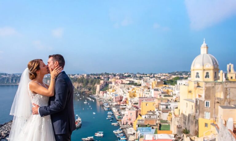 A kiss on a terrace above the harbour, the tiled dome beyond, O'Sarracino Events
