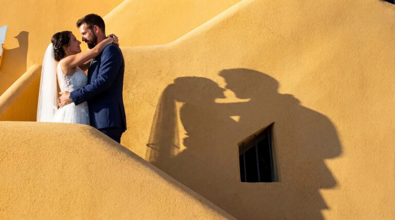 Against an ochre wall in full sun, their shadow thrown across it, O'Sarracino Events