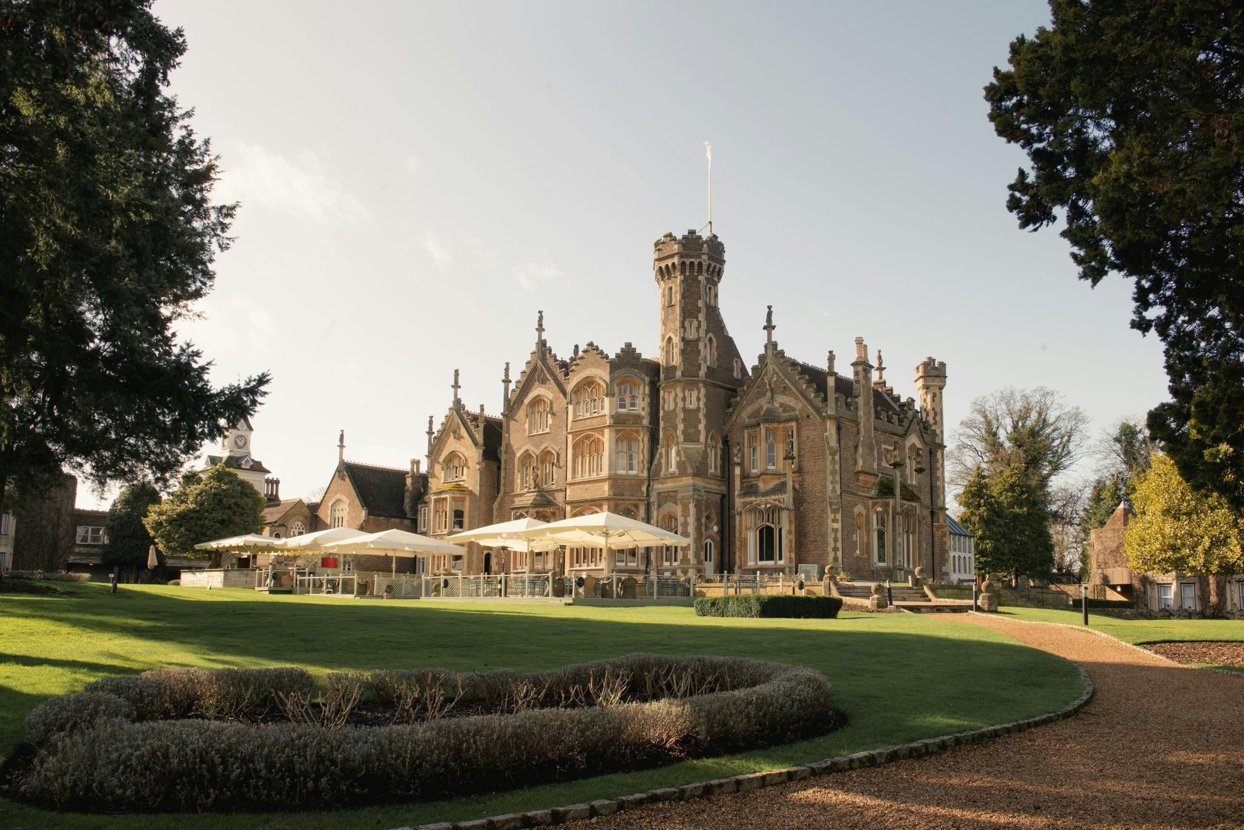 The Victorian mansion across the lawn, with the terrace restaurant on the right, Oakley Court Hotel, Windsor