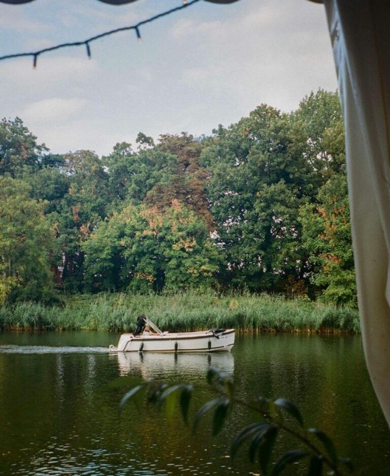 A boat on the water seen through the trees, Oakley Court Hotel, Windsor