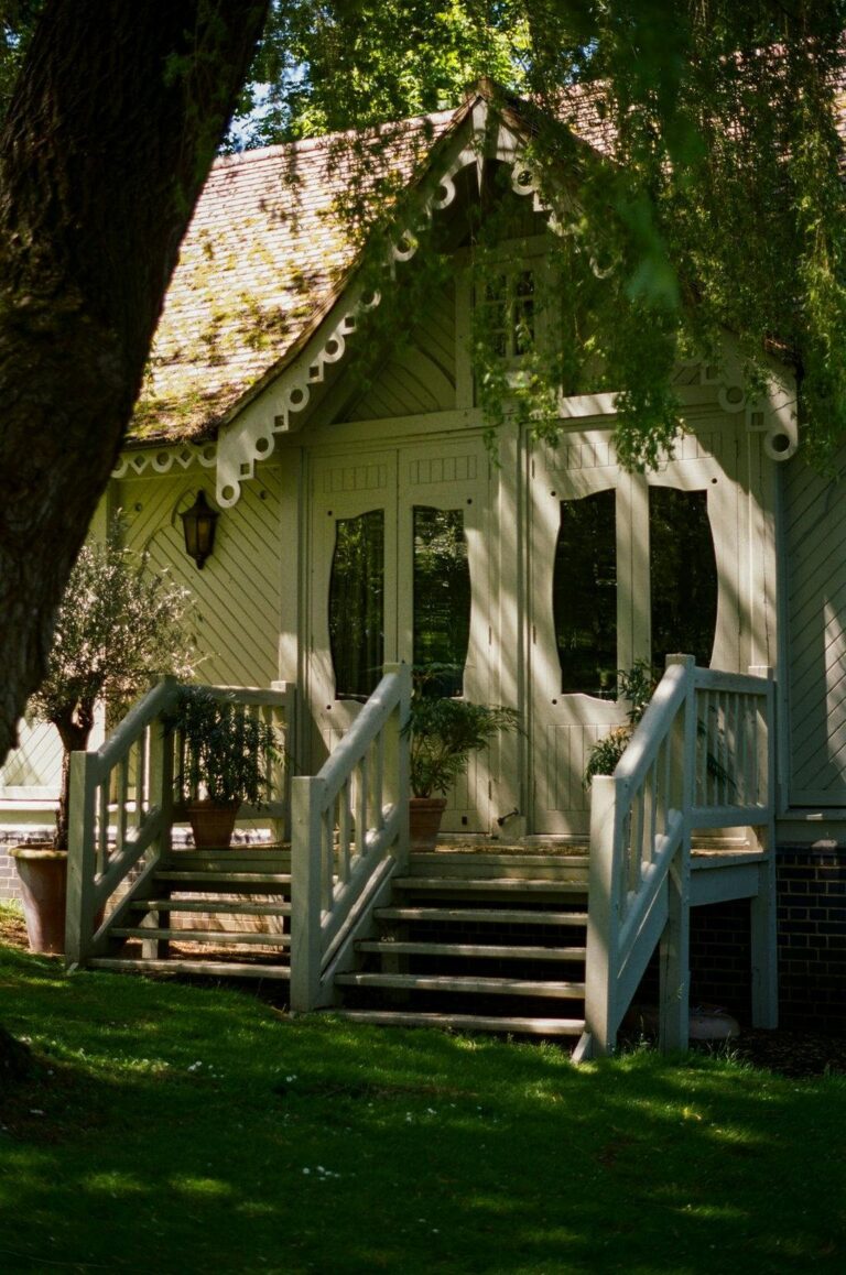 A white summerhouse with a timber veranda among the trees, Oakley Court Hotel, Windsor