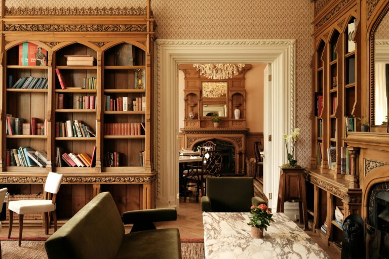 A mansion lounge with original woodwork and bookshelves, Oakley Court Hotel, Windsor