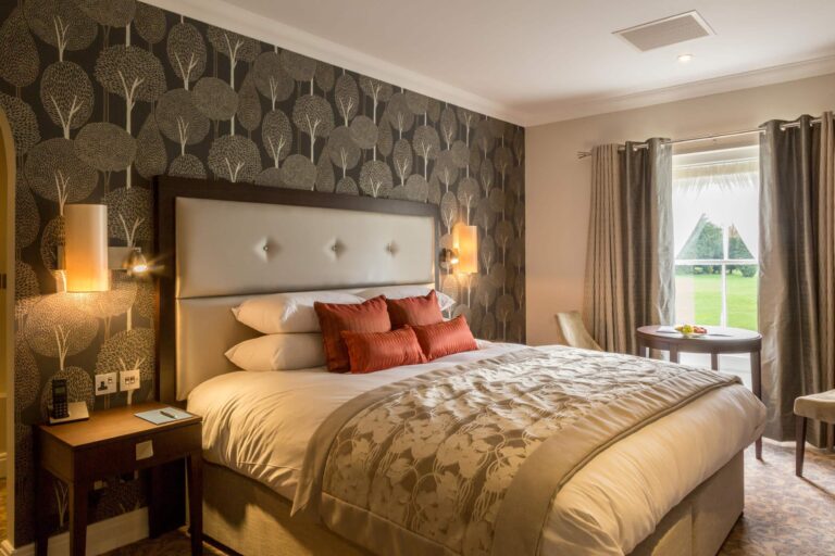 A Deluxe Bedroom with a super king bed and garden views, Oakley Hall Hotel