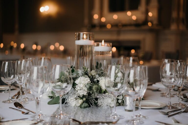 Floating candles, glassware and white flowers on a wedding table, Oakley Hall Hotel