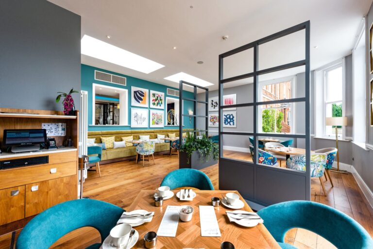 The Glasshouse Restaurant, with teal velvet chairs, timber tables and skylights, Oakley Hall Hotel