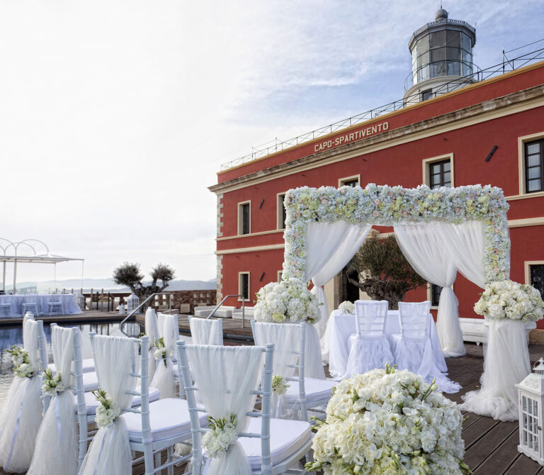 Ceremony arch of white flowers on the terrace of the Capo Spartivento lighthouse, Chia, Oggi Sposi & Events