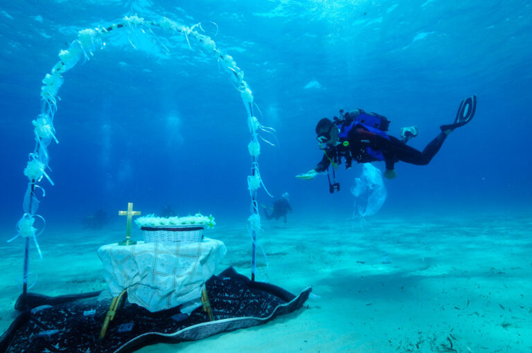 Divers at an underwater ceremony arch and altar on the seabed, south Sardinia, Oggi Sposi & Events