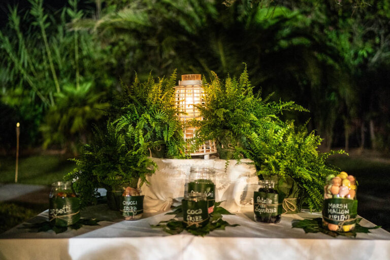 Dessert table dressed with ferns, palms and lanterns at night, Oggi Sposi & Events