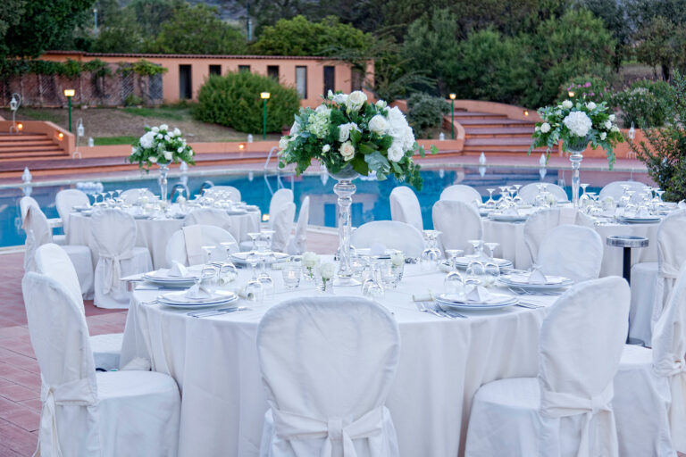 Poolside reception tables with tall white flower arrangements, Is Molas, Oggi Sposi & Events