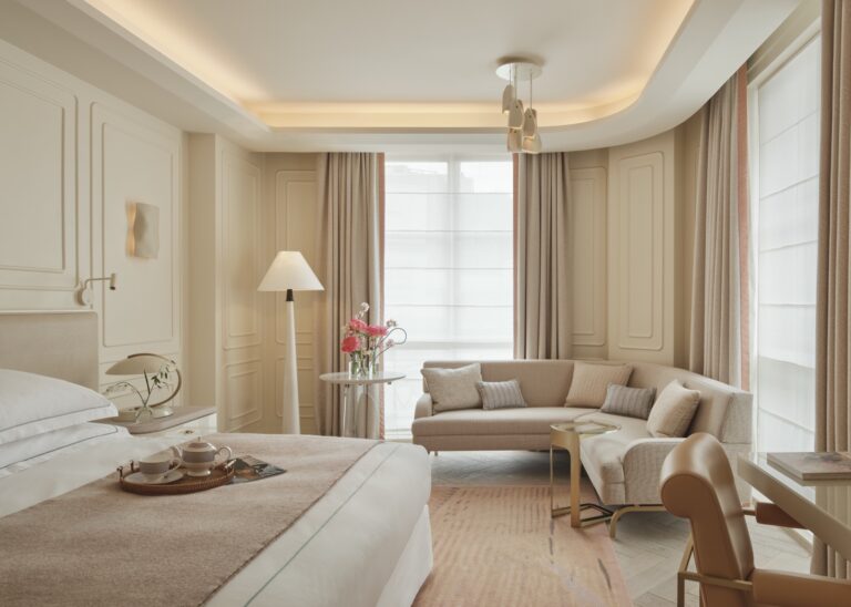 A Deluxe bedroom with a sofa and armchair by the window, One Aldwych