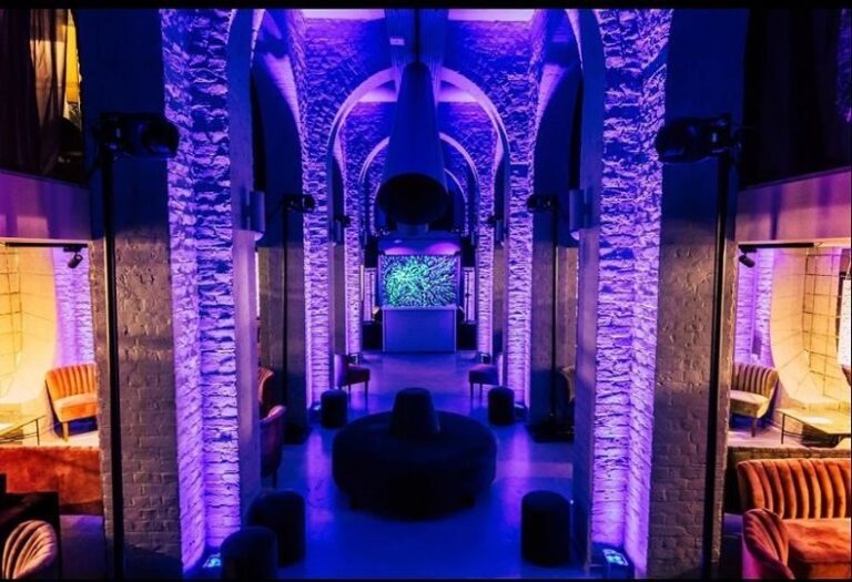 The blue-lit stone-columned Undercroft with soft seating for evening receptions, One Marylebone