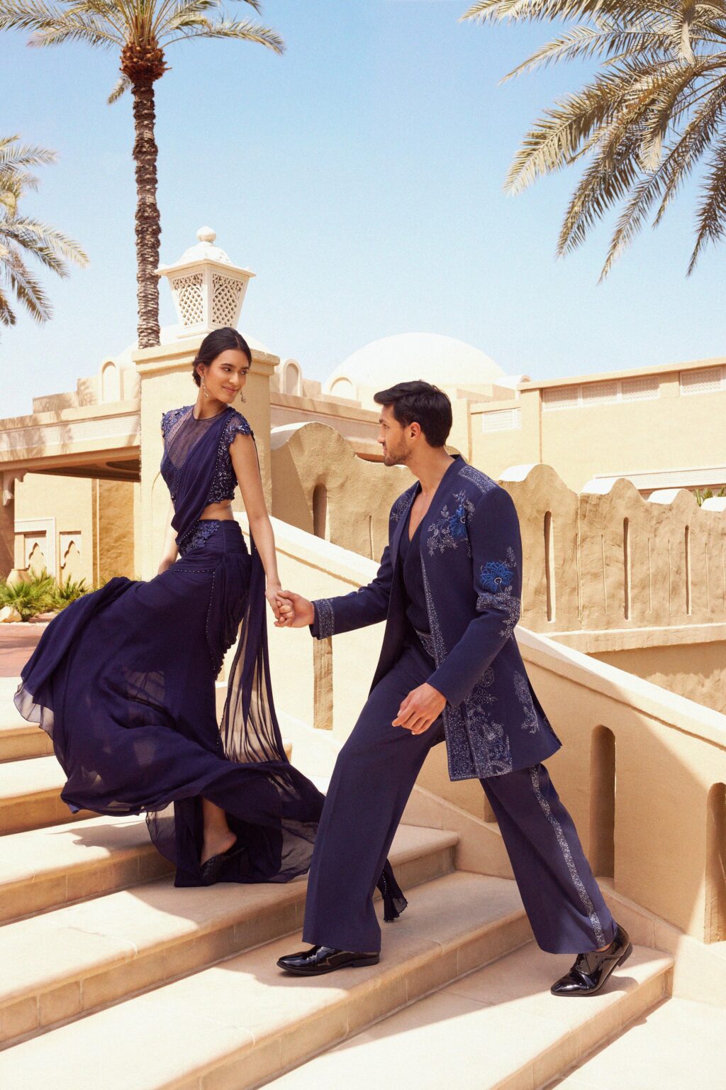A couple on a stone staircase in the resort grounds, One&Only Royal Mirage