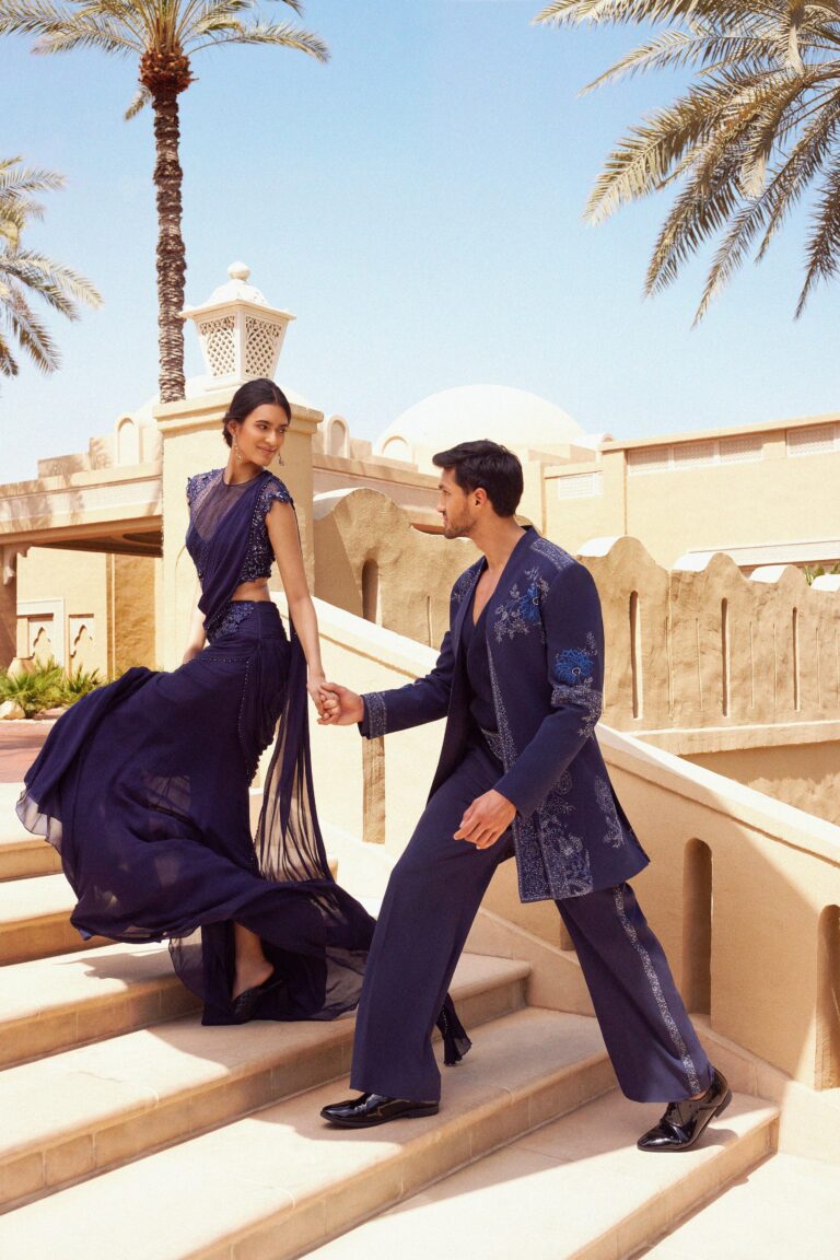 A couple on a stone staircase in the resort grounds, One&Only Royal Mirage