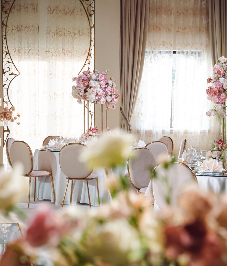 A reception room laid with round tables and floral arrangements, One&Only Royal Mirage